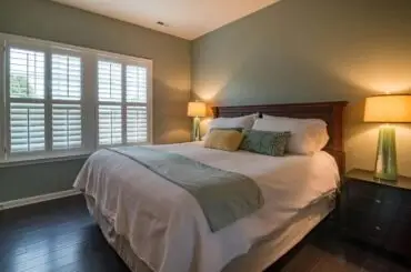 Stylish bedroom interior with cozy bed, elegant decor, and warm ambient lighting.